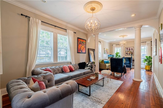 2134 Harmony St, New Orleans, LA 70115 - living area with ornate columns, a chandelier, healthy amount of natural light, and crown molding
