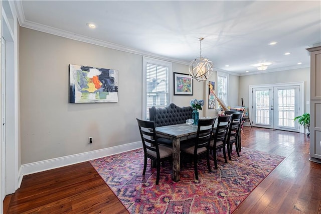 2134 Harmony St, New Orleans, LA 70115 - dining area with crown molding, a chandelier, recessed lighting, baseboards, and dark wood finished floors