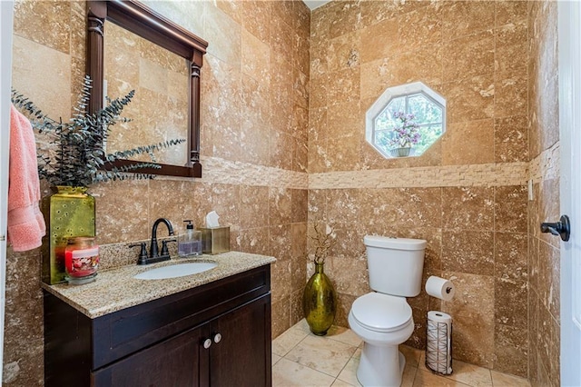 2134 Harmony St, New Orleans, LA 70115 - bathroom featuring vanity, toilet, tile walls, and tile patterned floors