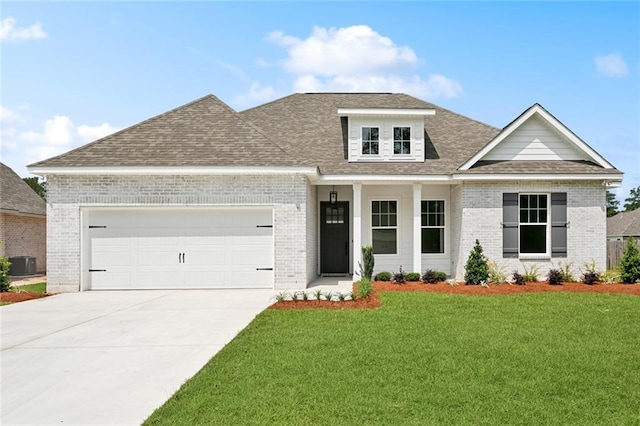 72665 Robindale Dr, Covington, LA 70434 - view of front of property featuring brick siding, an attached garage, central AC, driveway, and a front yard