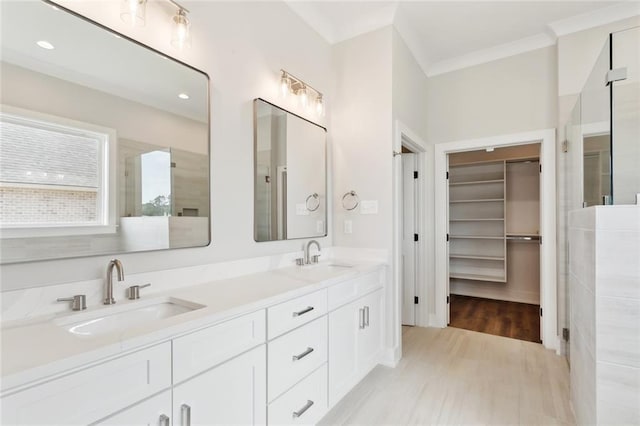 72665 Robindale Dr, Covington, LA 70434 - full bathroom with double vanity, a walk in closet, wood finished floors, crown molding, and recessed lighting