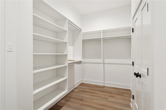 72665 Robindale Dr, Covington, LA 70434 - walk in closet featuring wood finished floors
