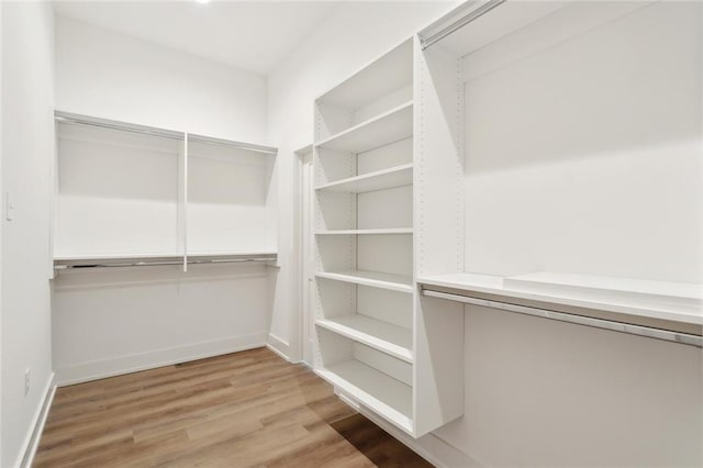 72665 Robindale Dr, Covington, LA 70434 - walk in closet with light wood-type flooring