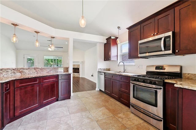 121 Gail Dr, La Place, LA 70068 - kitchen featuring stainless steel appliances, reddish brown cabinets, a sink, and plenty of natural light