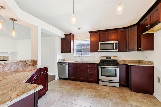 121 Gail Dr, La Place, LA 70068 - kitchen featuring appliances with stainless steel finishes, light stone countertops, a sink, pendant lighting, and baseboards