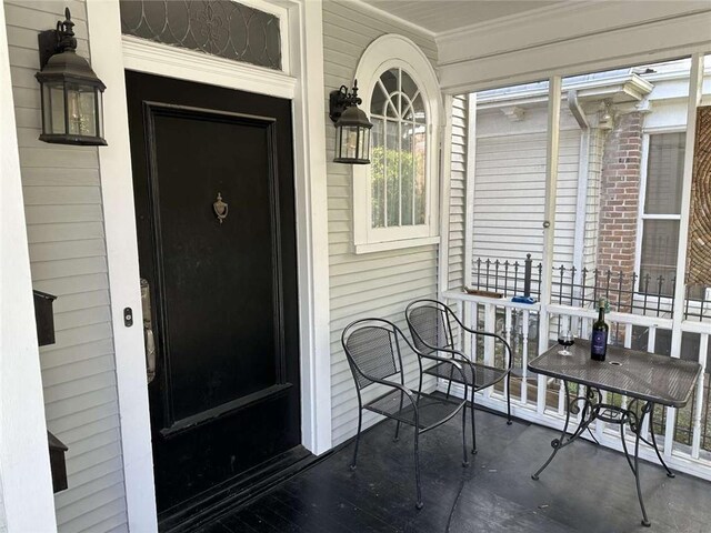1228 Pine St, New Orleans, LA 70118 - property entrance with a porch