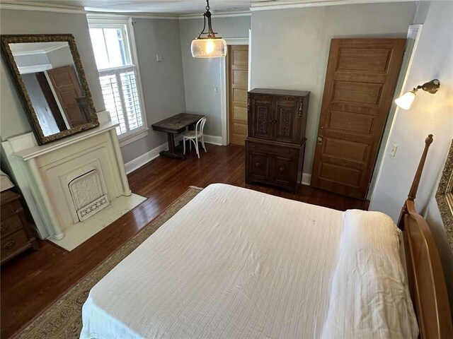 1228 Pine St, New Orleans, LA 70118 - bedroom with crown molding, dark wood-style flooring, and baseboards