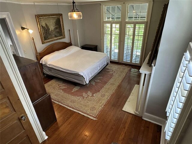 1228 Pine St, New Orleans, LA 70118 - bedroom with dark wood finished floors and ornamental molding
