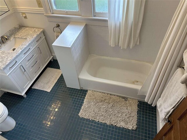 1228 Pine St, New Orleans, LA 70118 - bathroom featuring vanity, toilet, tile patterned flooring, and shower / bathtub combination with curtain