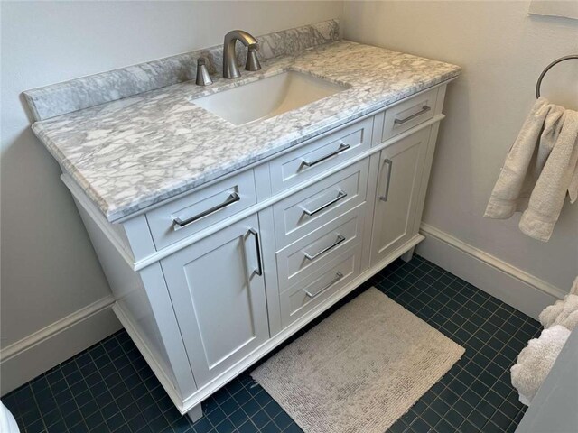 1228 Pine St, New Orleans, LA 70118 - bathroom featuring tile patterned floors, vanity, and baseboards