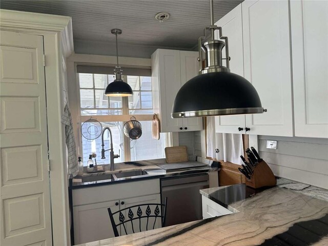 1228 Pine St, New Orleans, LA 70118 - kitchen with dishwashing machine, a sink, white cabinets, and decorative light fixtures