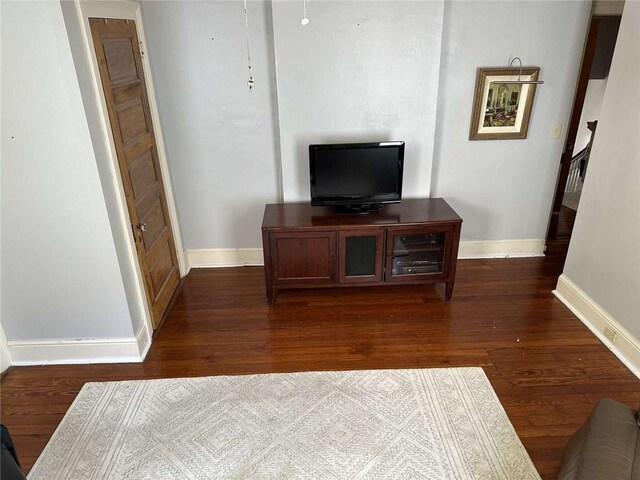 1228 Pine St, New Orleans, LA 70118 - living area with baseboards and dark wood-style flooring