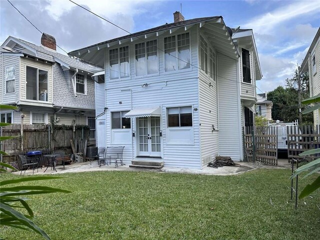 1228 Pine St, New Orleans, LA 70118 - back of house with entry steps, a chimney, and a patio