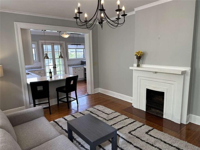 1228 Pine St, New Orleans, LA 70118 - living room featuring ornamental molding, a chandelier, dark wood-style flooring, and baseboards