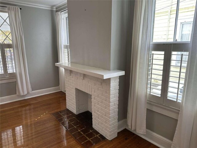 1228 Pine St, New Orleans, LA 70118 - unfurnished living room featuring dark wood-style flooring, healthy amount of natural light, ornamental molding, and baseboards