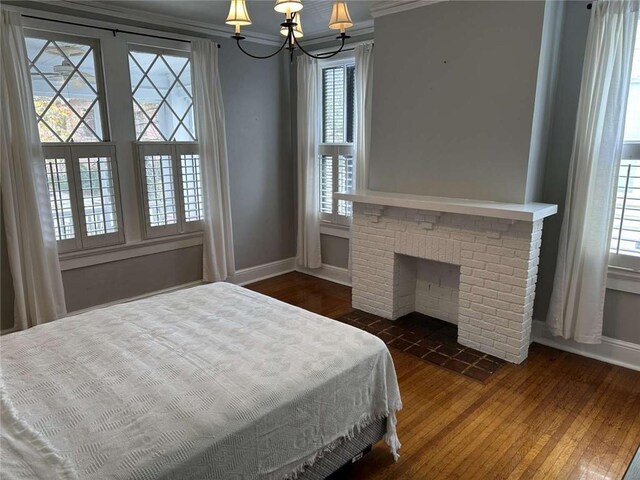 1228 Pine St, New Orleans, LA 70118 - bedroom with wood-type flooring, baseboards, ornamental molding, multiple windows, and a chandelier