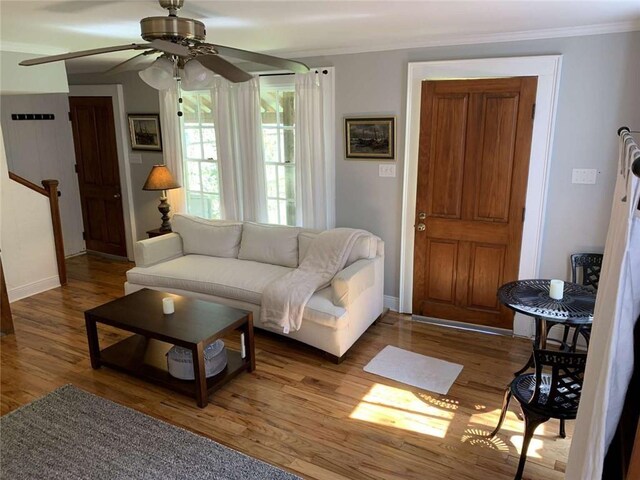 1228 Pine St, New Orleans, LA 70118 - living area with a ceiling fan, crown molding, wood finished floors, and baseboards
