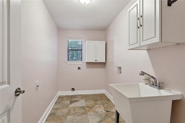 335 Devon Rd, La Place, LA 70068 - laundry room with cabinet space, hookup for a washing machine, hookup for an electric dryer, baseboards, and a textured ceiling