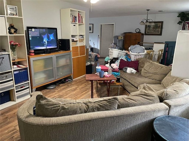 1127 Cousin St, Slidell, LA 70458 - living room featuring wood finished floors and a chandelier