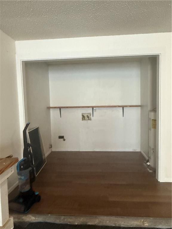 106 Leonell Cir, Slidell, LA 70458 - laundry area with wood finished floors, water heater, and a textured ceiling