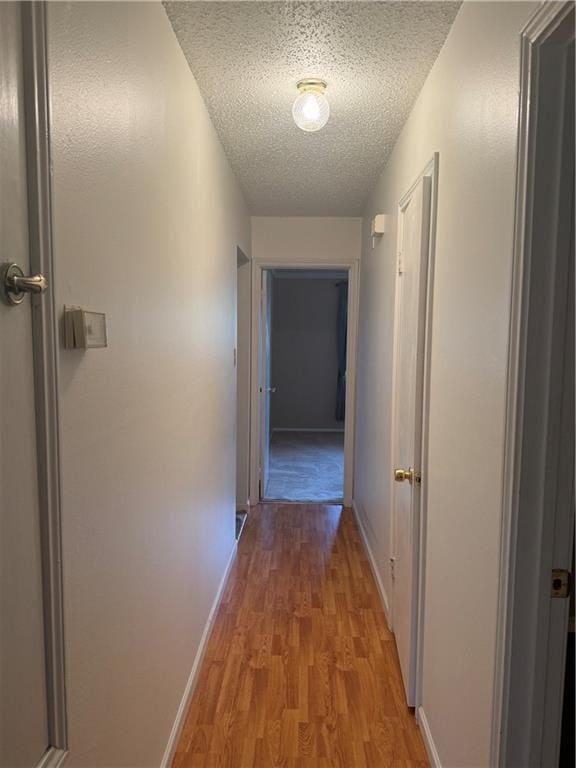 106 Leonell Cir, Slidell, LA 70458 - hall featuring light wood-style flooring, a textured ceiling, and baseboards