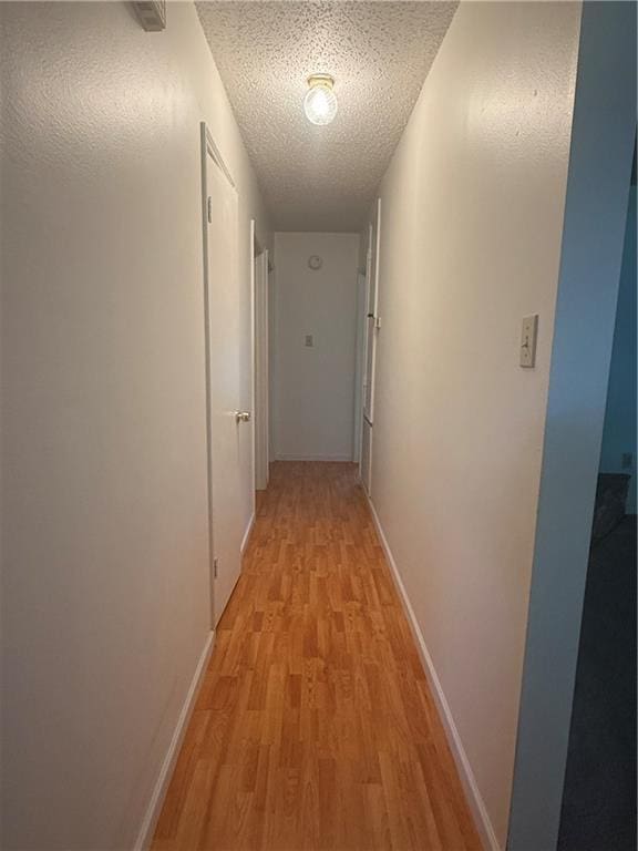 106 Leonell Cir, Slidell, LA 70458 - hall with light wood-type flooring, baseboards, and a textured ceiling