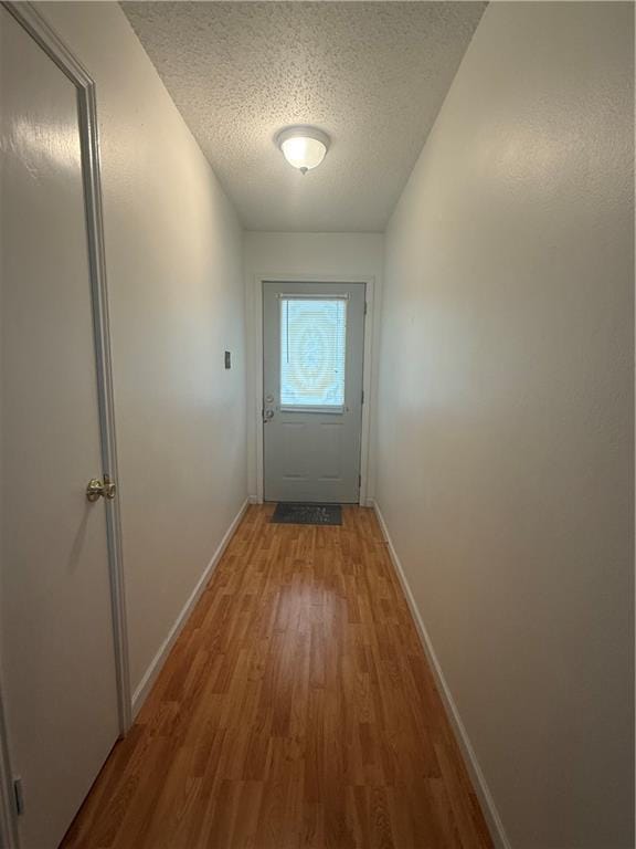 106 Leonell Cir, Slidell, LA 70458 - doorway to outside with baseboards, wood finished floors, and a textured ceiling