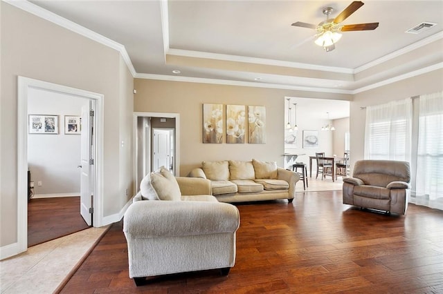 410 Lakewood Dr, Luling, LA 70070 - living room featuring a tray ceiling, ceiling fan, crown molding, wood finished floors, and baseboards