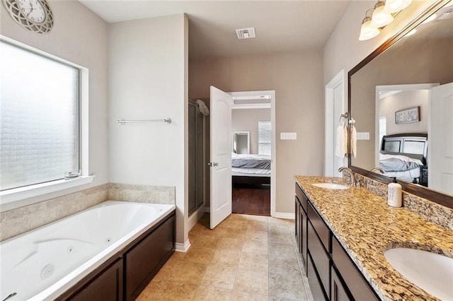 410 Lakewood Dr, Luling, LA 70070 - ensuite bathroom with a whirlpool tub, double vanity, a stall shower, and baseboards