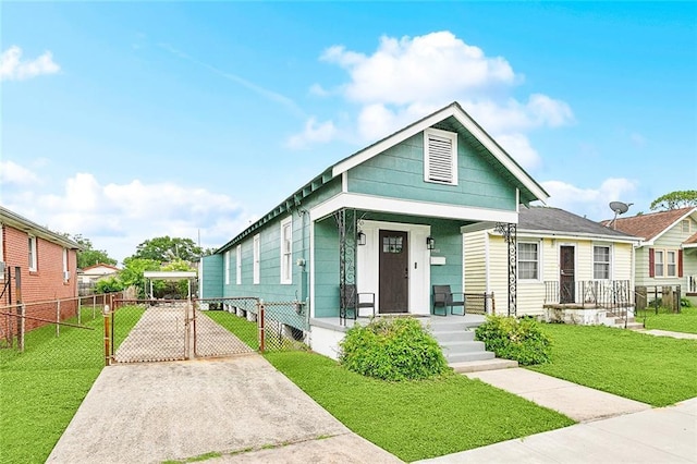 4409 Annette St, New Orleans, LA 70122 - shotgun-style home featuring a gate, covered porch, and concrete driveway