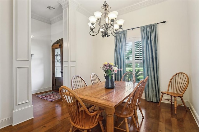 229 Pine Crest Dr, Madisonville, LA 70447 - dining area with arched walkways, ornamental molding, dark wood-type flooring, a chandelier, and baseboards