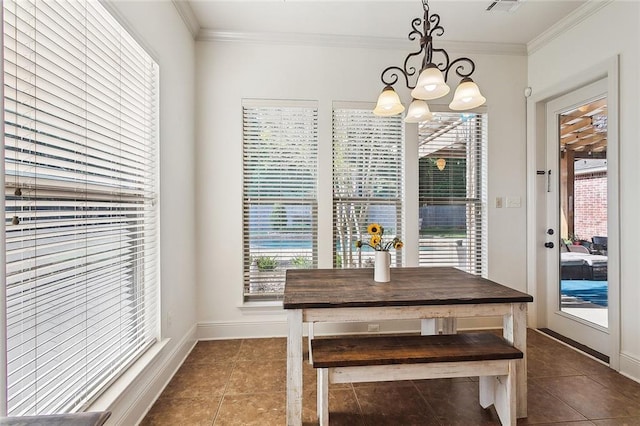 229 Pine Crest Dr, Madisonville, LA 70447 - dining room with a chandelier, plenty of natural light, dark tile patterned flooring, crown molding, and baseboards