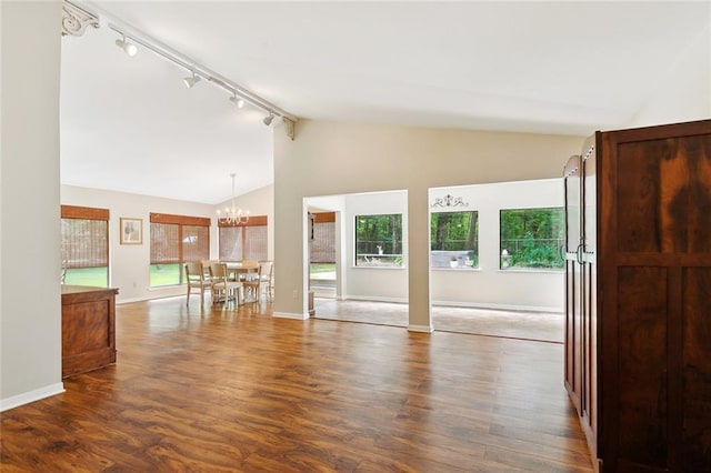 71152 Cutter Pl, Abita Springs, LA 70420 - unfurnished living room with rail lighting, a chandelier, wood finished floors, baseboards, and high vaulted ceiling