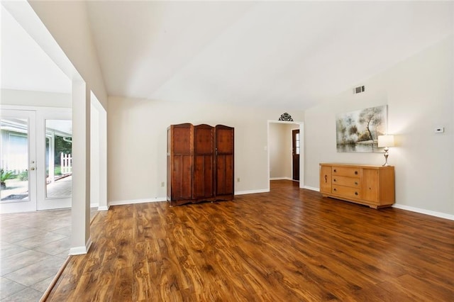 71152 Cutter Pl, Abita Springs, LA 70420 - unfurnished living room with lofted ceiling, wood finished floors, baseboards, and french doors