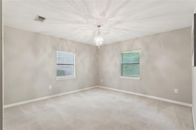 71152 Cutter Pl, Abita Springs, LA 70420 - unfurnished room with carpet floors, a chandelier, baseboards, and a textured ceiling