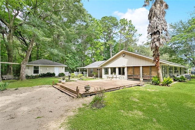 71152 Cutter Pl, Abita Springs, LA 70420 - rear view of property featuring a wooden deck, a lawn, and a sunroom