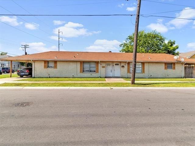 340103 Frenchmen St, New Orleans, LA 70122 - ranch-style house with an attached carport and a front yard