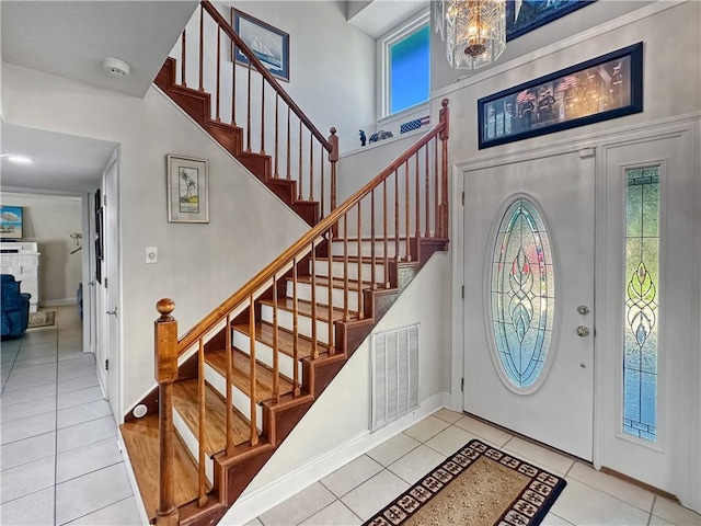 177 Moonraker Dr, Slidell, LA 70458 - foyer entrance with tile patterned flooring, stairs, baseboards, a towering ceiling, and a chandelier