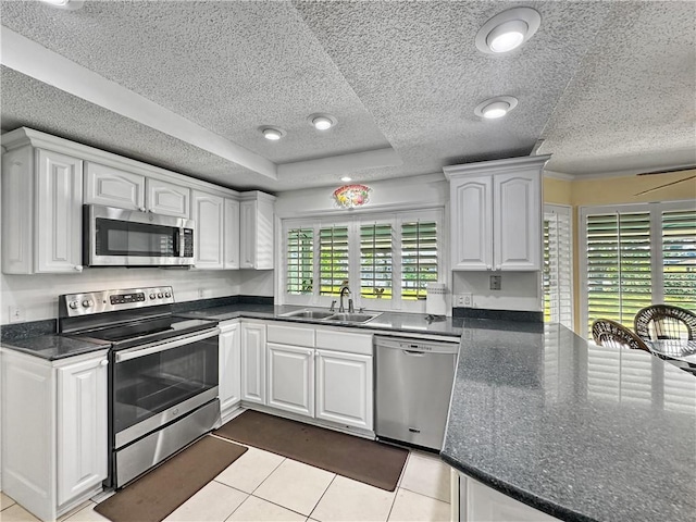 177 Moonraker Dr, Slidell, LA 70458 - kitchen with stainless steel appliances, white cabinetry, a sink, and a textured ceiling