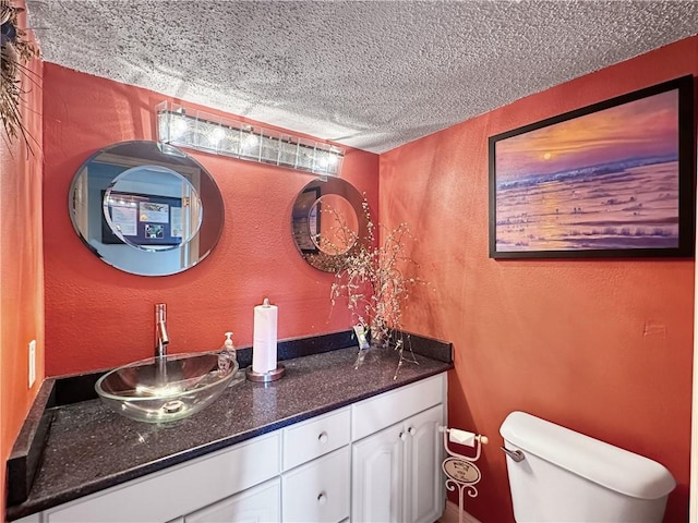 177 Moonraker Dr, Slidell, LA 70458 - bathroom featuring a textured wall, a textured ceiling, vanity, and toilet