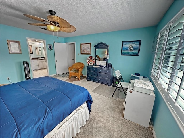 177 Moonraker Dr, Slidell, LA 70458 - bedroom with a textured ceiling, a ceiling fan, ensuite bath, carpet flooring, and baseboards