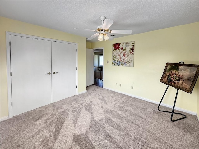 177 Moonraker Dr, Slidell, LA 70458 - unfurnished bedroom featuring carpet floors, baseboards, a textured ceiling, a ceiling fan, and a closet