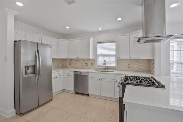 227 20th St, New Orleans, LA 70124 - kitchen with appliances with stainless steel finishes, a sink, island range hood, white cabinets, and crown molding
