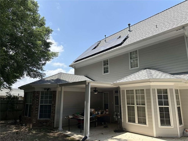 108 Riverbirch Dr, Lafayette, LA 70508 - back of property featuring ceiling fan, a patio area, roof mounted solar panels, and roof with shingles