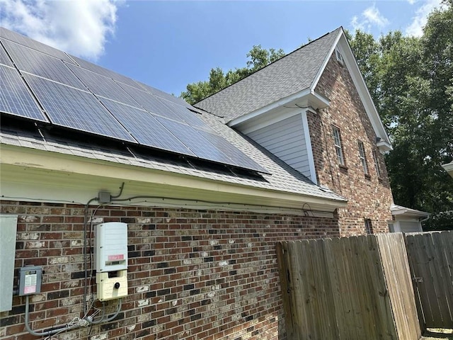 108 Riverbirch Dr, Lafayette, LA 70508 - view of side of home featuring brick siding, roof mounted solar panels, and roof with shingles