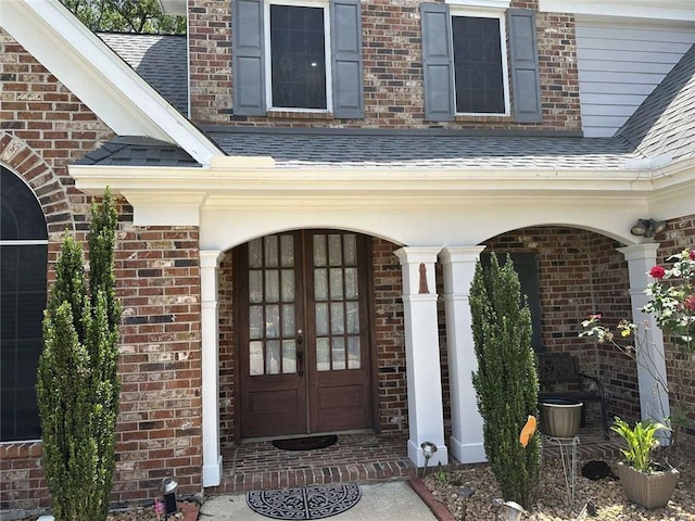 108 Riverbirch Dr, Lafayette, LA 70508 - property entrance with a shingled roof, brick siding, and covered porch