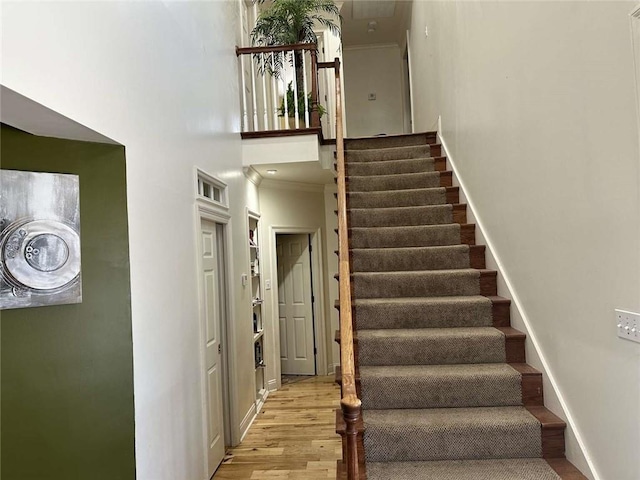 108 Riverbirch Dr, Lafayette, LA 70508 - stairs featuring wood finished floors, a towering ceiling, and baseboards