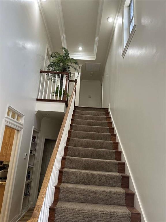 108 Riverbirch Dr, Lafayette, LA 70508 - staircase with ornamental molding, a high ceiling, baseboards, and recessed lighting