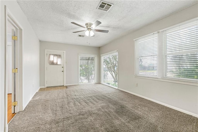 501 Gaudet Dr, Marrero, LA 70072 - foyer entrance featuring a ceiling fan, carpet floors, baseboards, and a textured ceiling