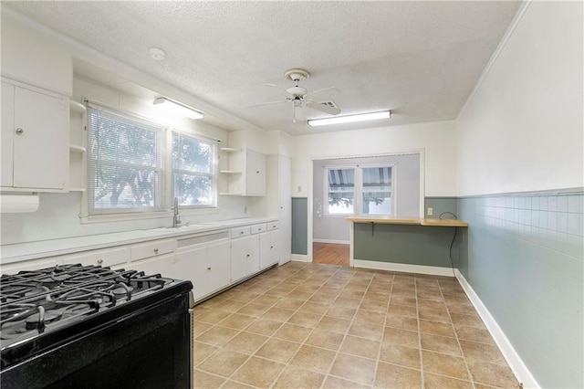 501 Gaudet Dr, Marrero, LA 70072 - kitchen featuring open shelves, black range with gas cooktop, ceiling fan, white cabinetry, and a textured ceiling